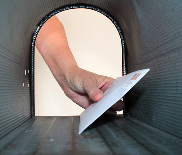 Mail Fraud Image - Hand reaching into mailbox