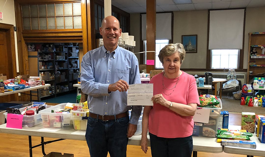 Photo of Tom Seyffert, NSB Manager, presenting a $1,500 Jeans Day donation to Phyllis Maxwell of the Reading Food Pantry