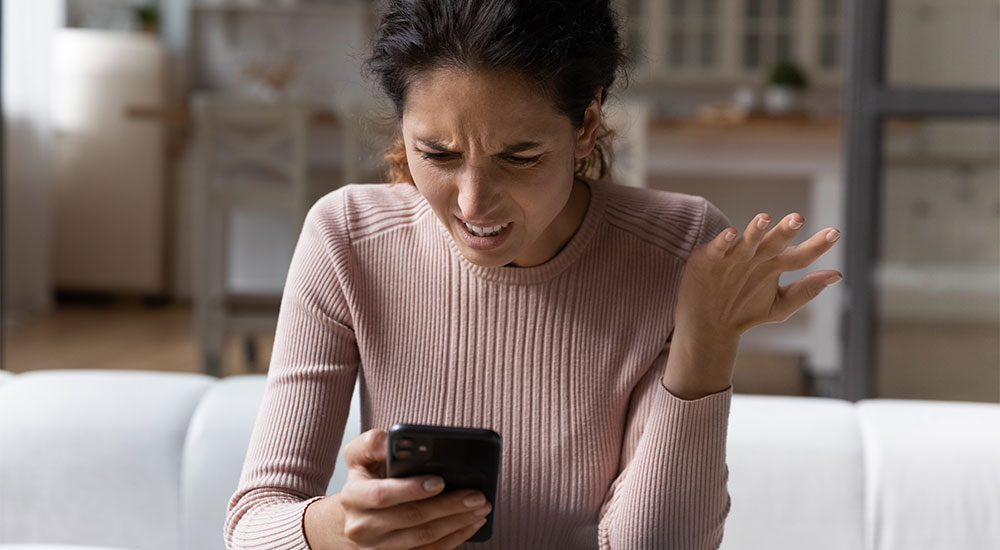 Image of woman receiving a spam text message