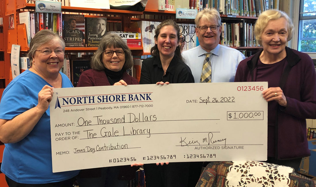 Photo of North Shore Bank presenting the Gale Library in Newton, NH with a $1,000 Jeans Day check.