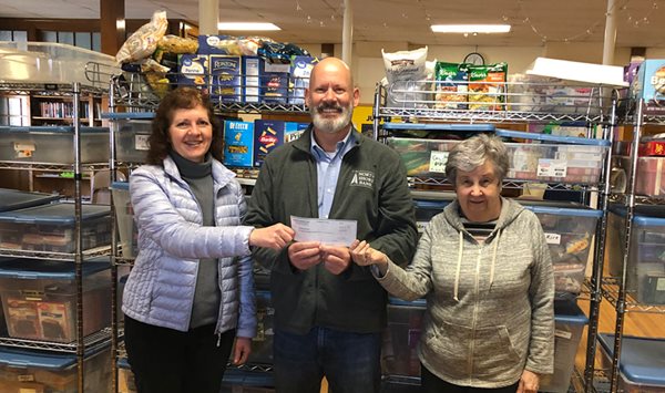 Photo of North Shore Bank presenting a $1,200 Jeans Day check to the Reading Food Pantry