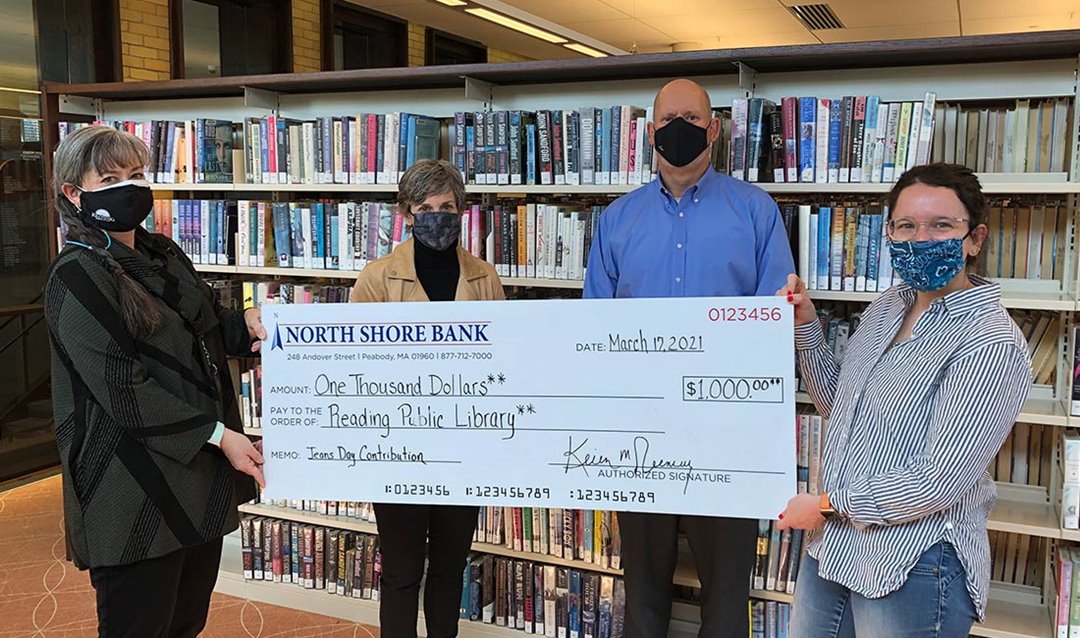 Photo of North Shore Bank Jeans Day donation to the Reading Public Library
