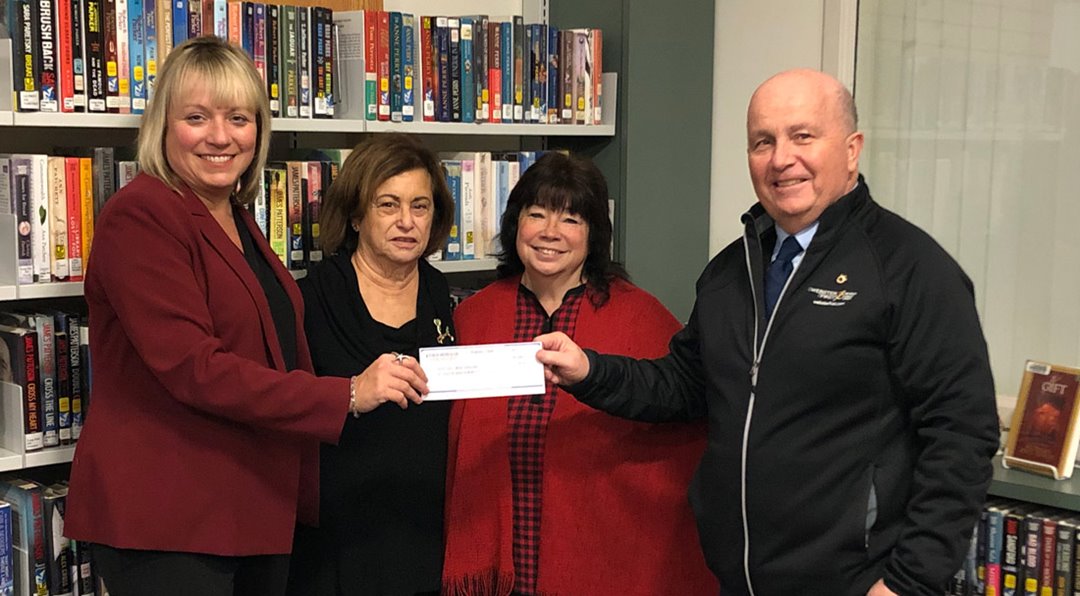 Photo of North Shoer Bank presenting a $1,900 dollar donation to the Foundation of the Saugus Public Library.  
