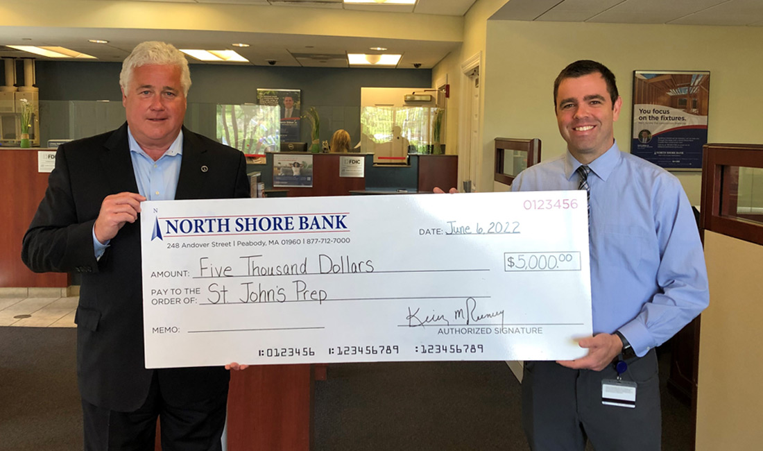 Photo of North Shore Bank CEO Kevin Tierney, presenting a donation to St. John's Prep Director of Annual Giving Paul Chiozzi