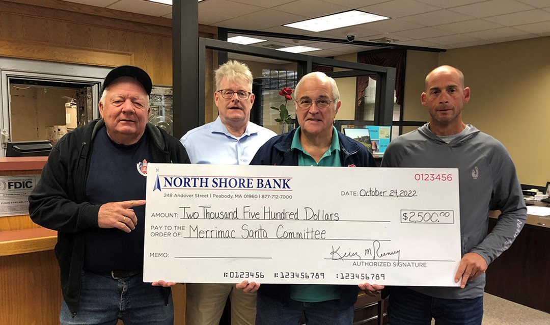 Photo of North Shore Bank presenting a $2,500 donation to the Merrimac Santa Parade Committee