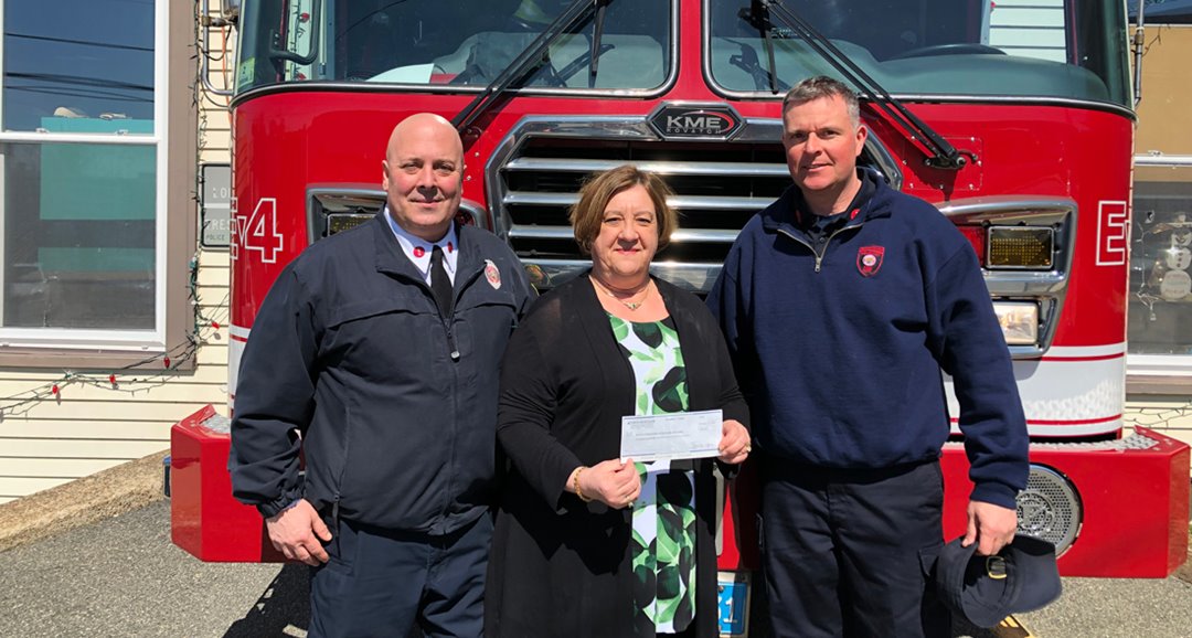 Mary Lou DaSilva, NSB Branch Manager presents Chris Dowling and Steve Pellegrini with a donation to the Peabody Firefighters.