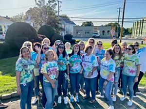 Employees Wearing Tie Dye Posing Together