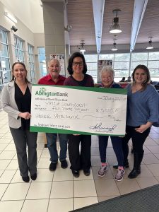 People holding a giant donation check for Full Plate Project.