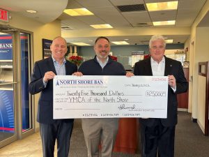 A group of three people hold a check donation to the YMCA of the North Shore.