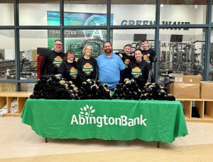 A group of volunteers behind a table at the Shawn Cotter Memorial Basketball Tournament